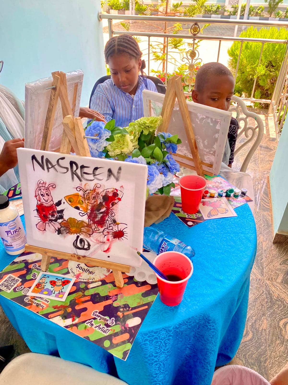 A young participant expressing creativity on canvas