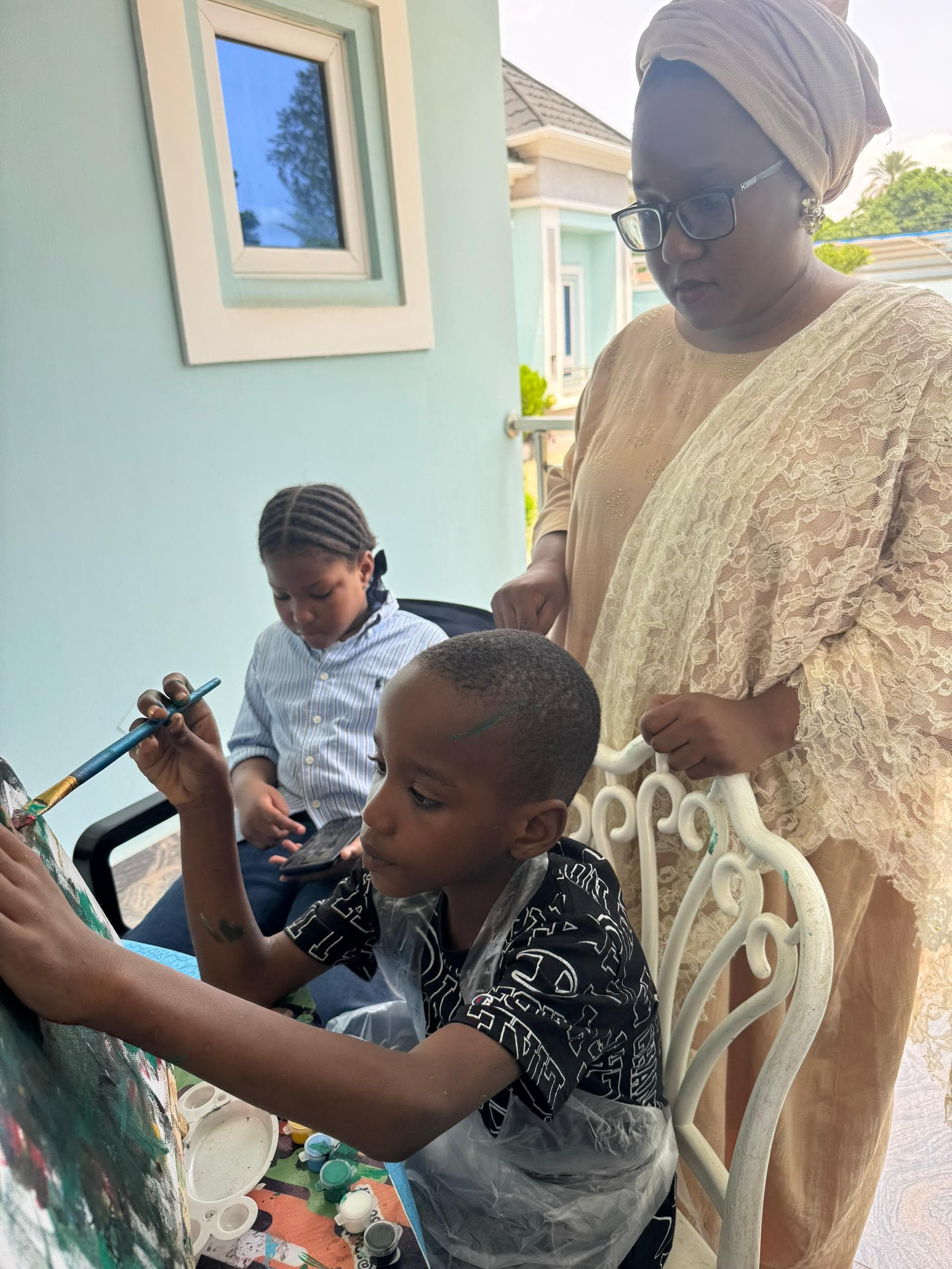 A parent and child painting side by side